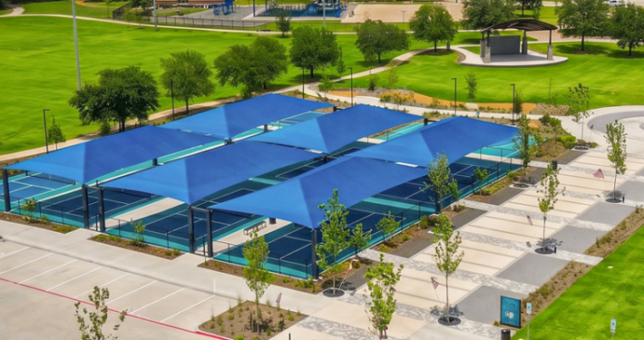 An aerial shot of Towne Center Park looking over the blue shade covers of the pickleball court.