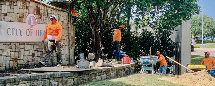 Employees of D&D Landscape work on the City Entryway on FM 740.