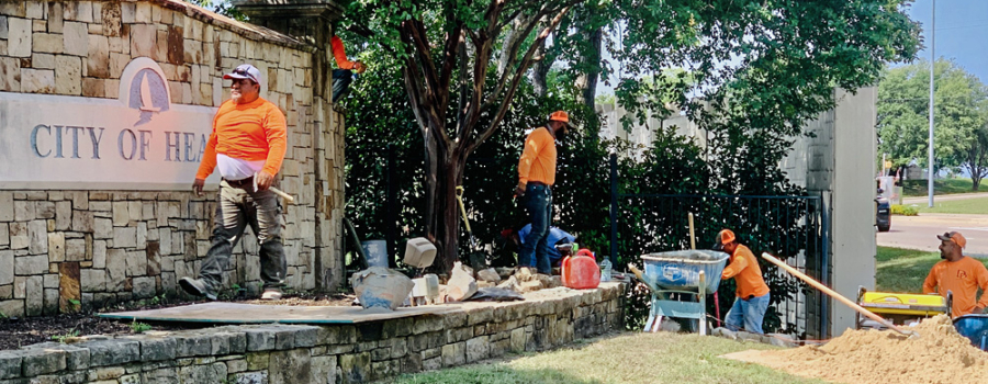 Employees of D&D Landscape work on the City Entryway on FM 740.