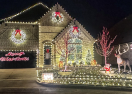 A beautiful 2 story house lit up with hundreds of Christmas LIghts.