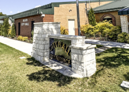 A stone monument sign in front of City Hall.