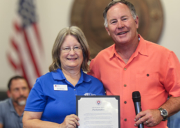 Resident Becky Burkett accepts the proclamation from Mayor Elam.