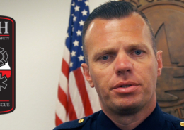 Heath DPS Chief Brandon Seery standing in front to the City of Heath seal at City Hall.