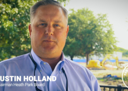 Parks Board Chairman Justin Holland standing in Towne Center Park with construction equipment in the background.