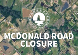 An aerial map graphic announcing a road closure. The City of Heath, Texas seal is centered above large white text reading 'MCDONALD ROAD CLOSURE'. On the left side of the map, a specific section of McDonald Rd is highlighted in yellow with a red outline, indicating the exact location of the closed portion.