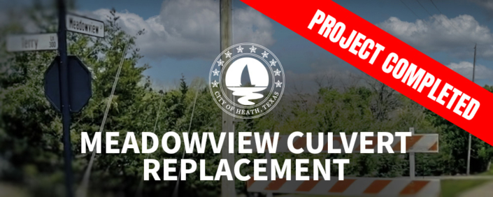 Entrance to Meadowview Road with a red banner saying"Project Complete".