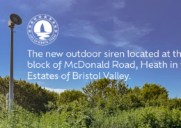 The new outdoor siren located at the 700 block of McDonald Road in Heath, surrounded by trees under a clear blue sky.