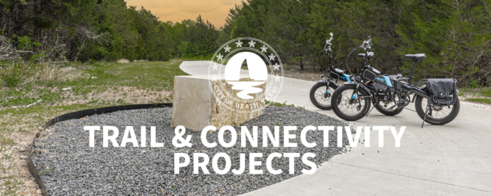 Two bicycles parked at the trail head of a hike and bike trail in Heath Crossing at sunset.
